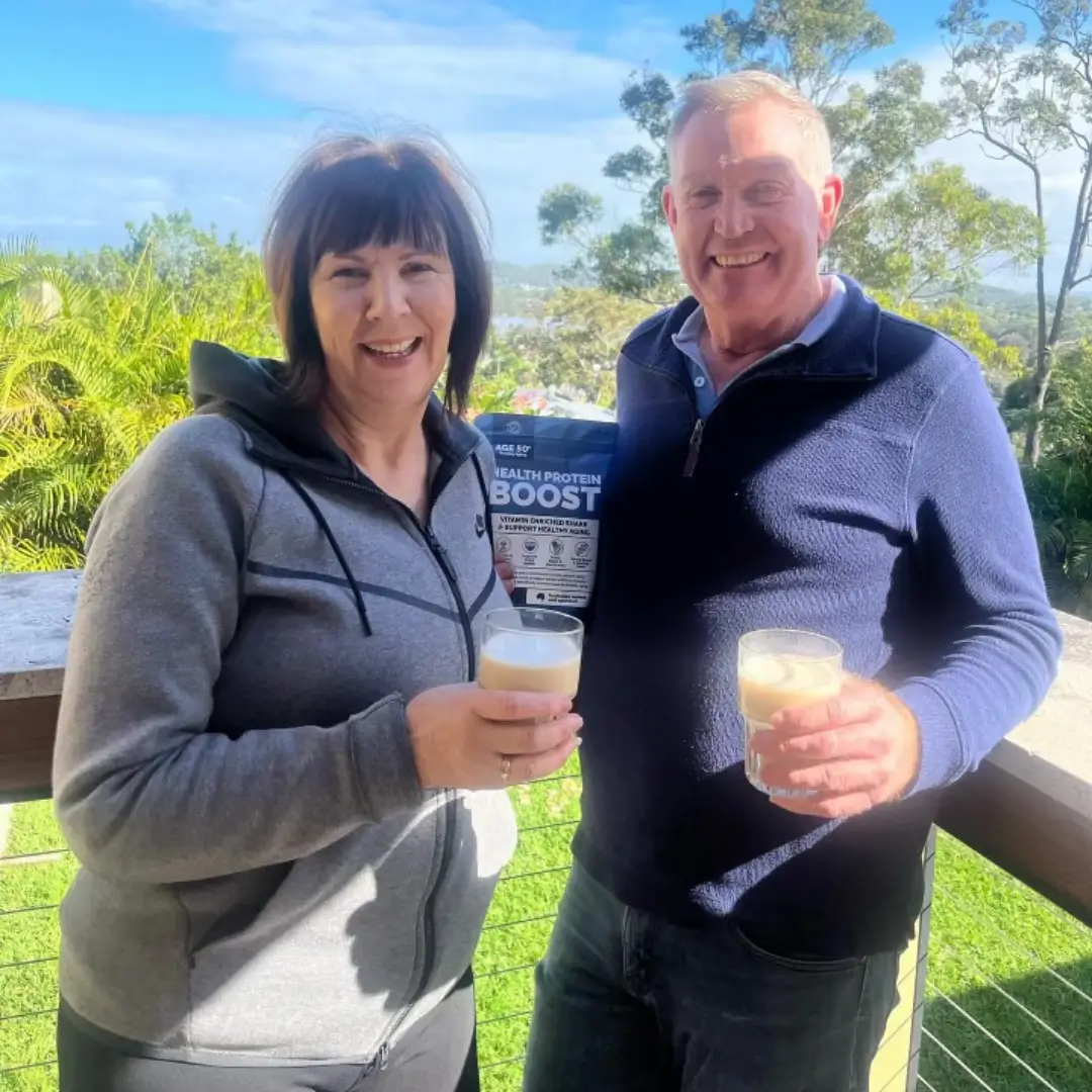 Couple on balcony enjoying Health Protein Boost shakes